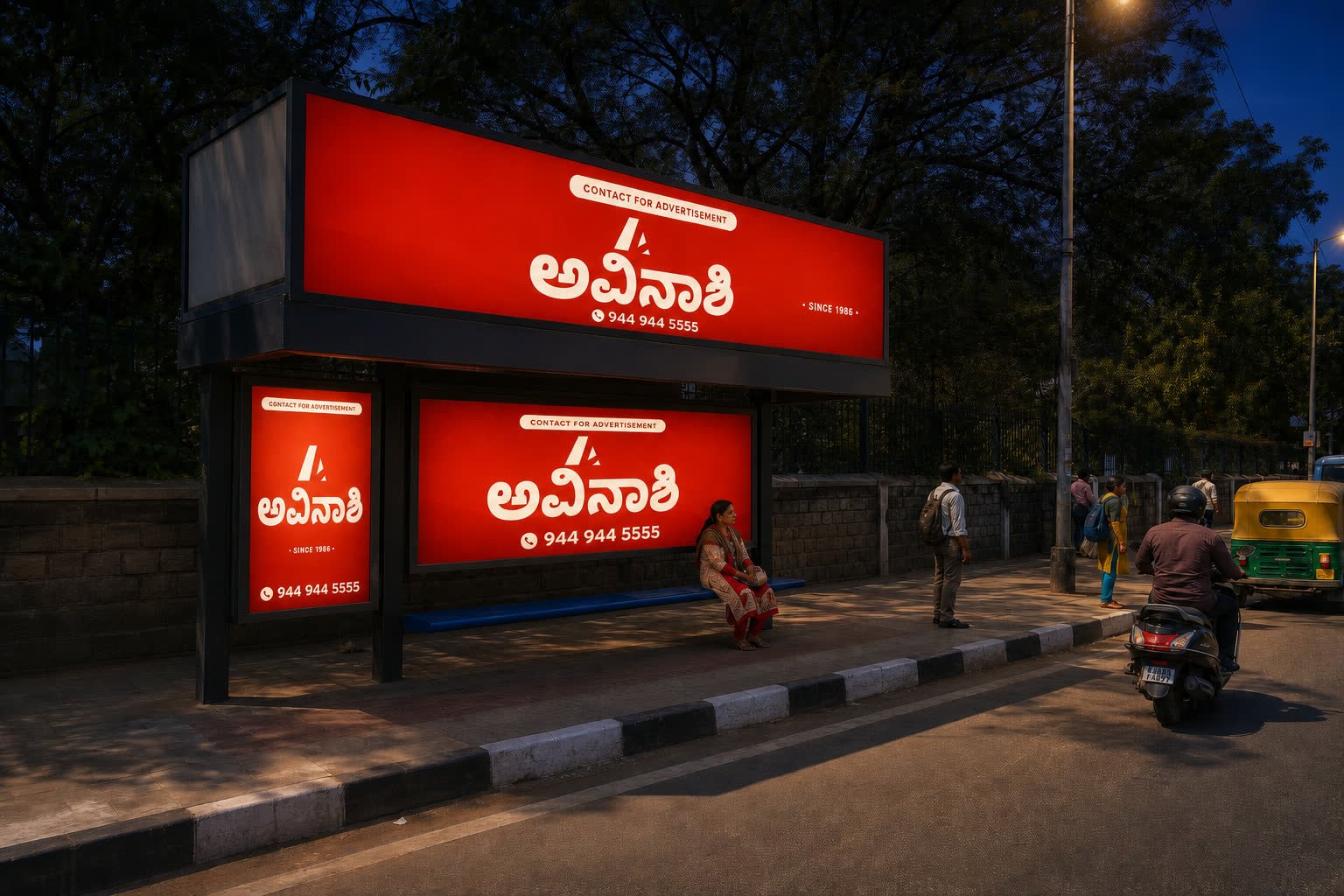 Backlit Avinashi Ads bus shelter media at night