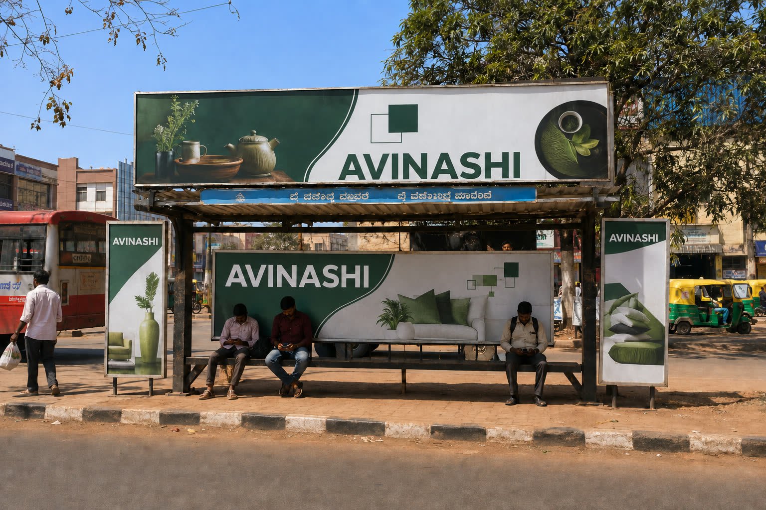 Bus shelter advertising on a commercial road in Hubballi during the day