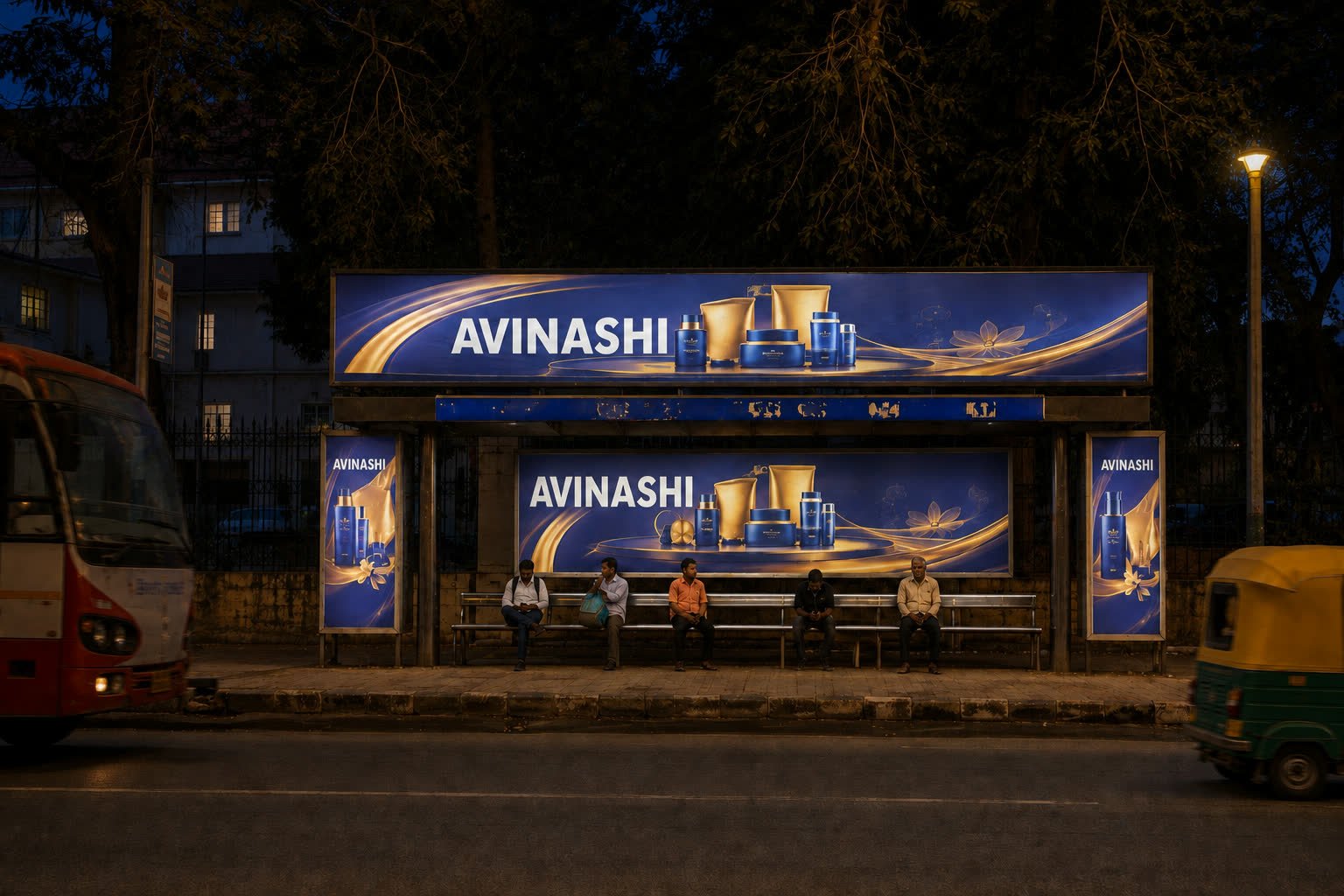 The same Mysuru bus shelter with its display illuminated at night