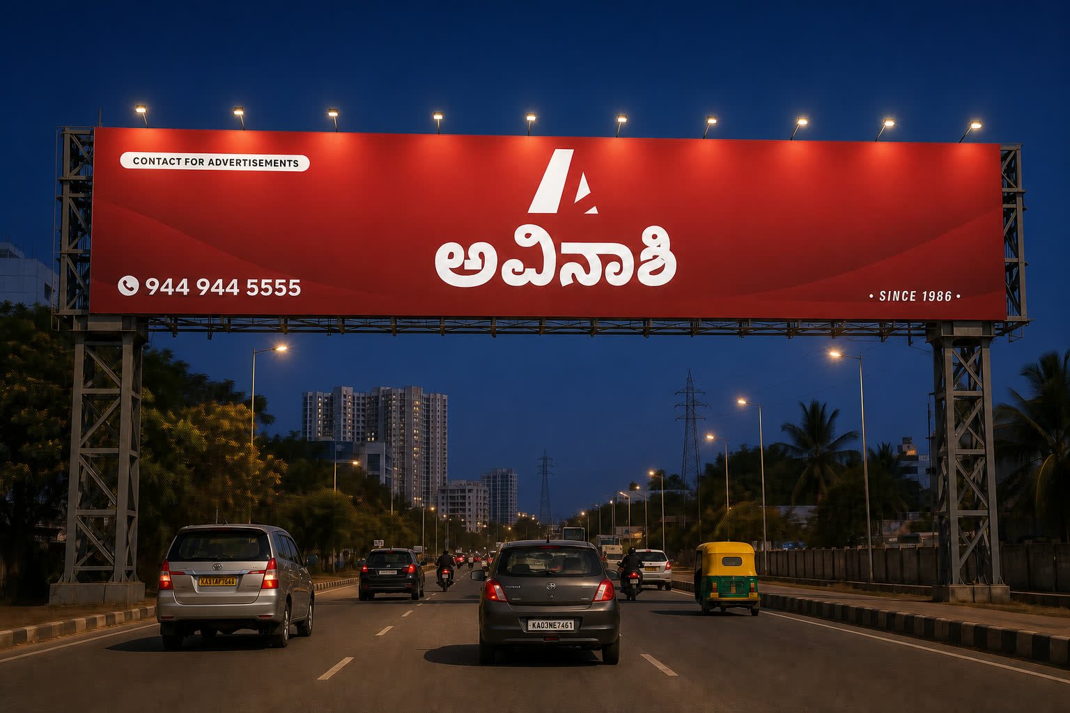 Illuminated Avinashi Ads road-spanning gantry at night