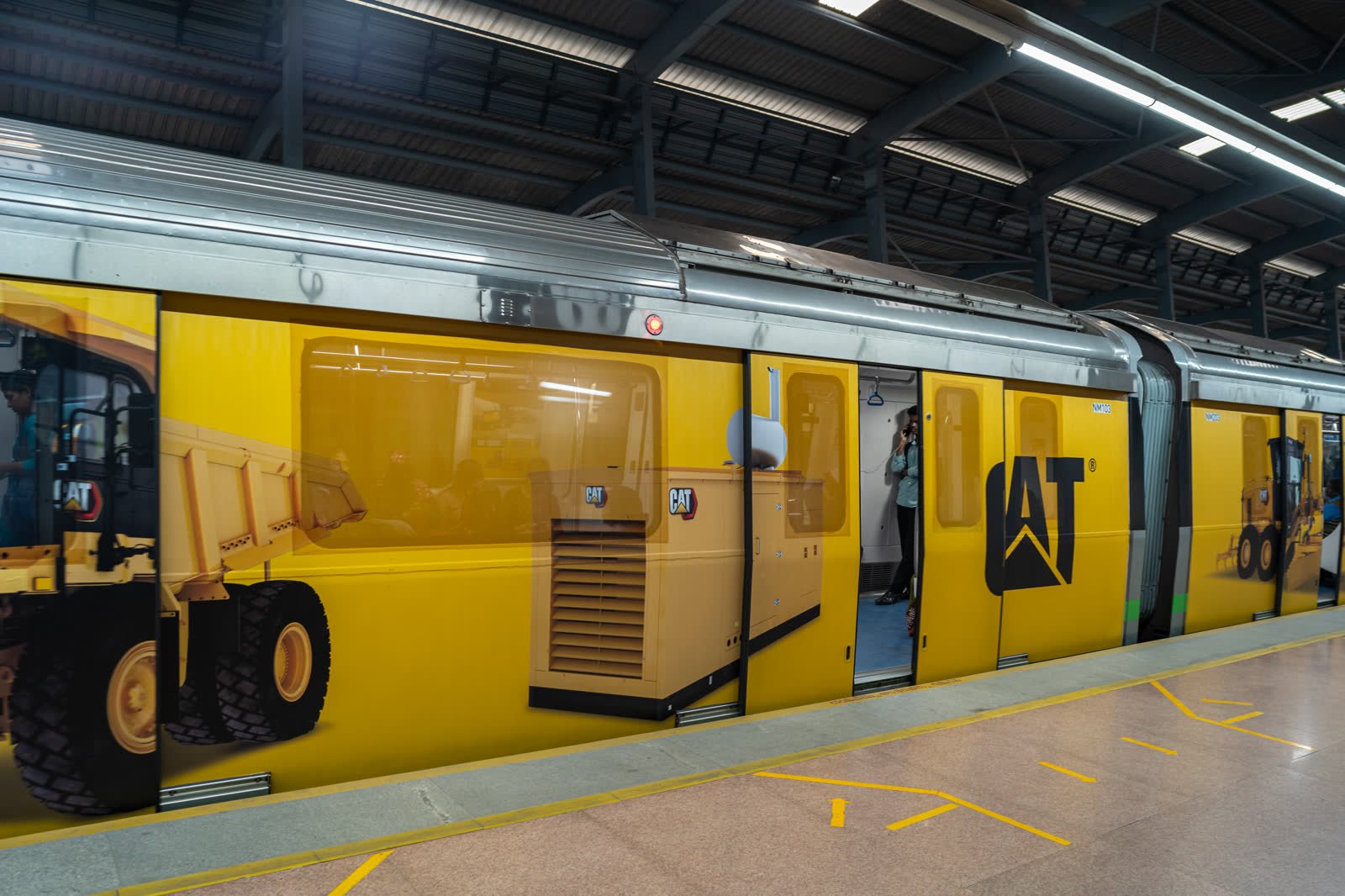 Caterpillar campaign wrapped across a Namma Metro train