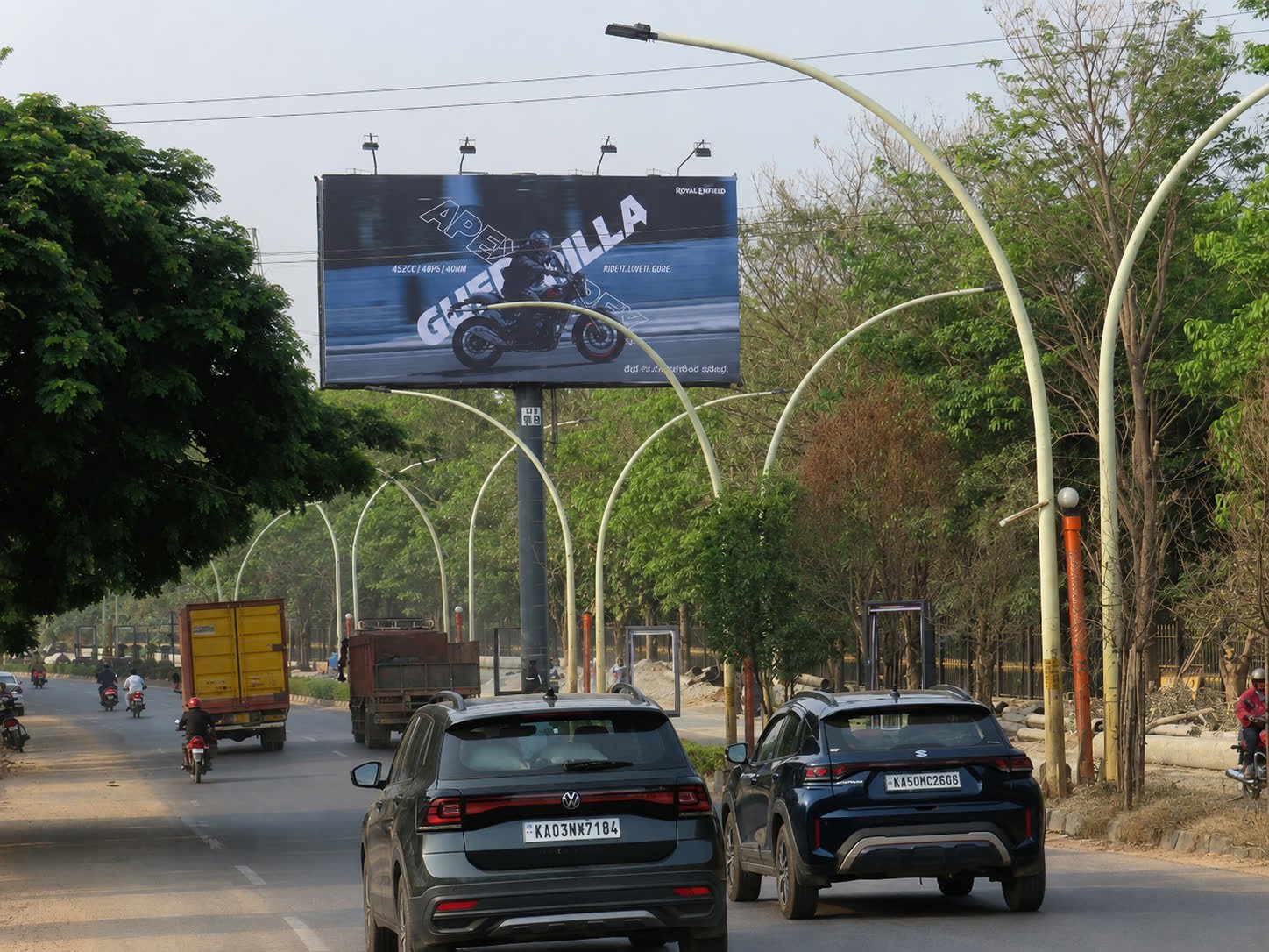 Unipole on the Yelahanka approach from Ramanashree Resort toward RMZ Mall during the day