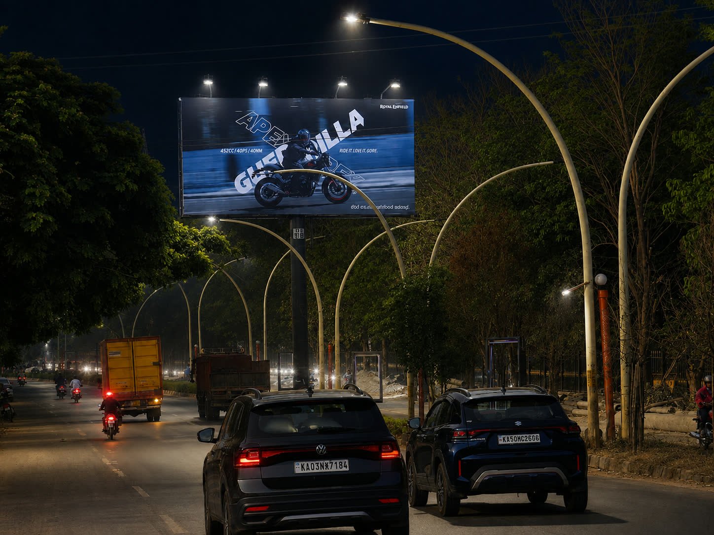 Illuminated unipole on the Yelahanka approach from Ramanashree Resort toward RMZ Mall at night